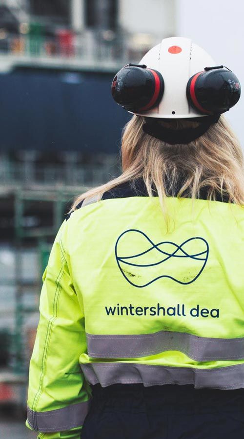 Two Wintershall Dea employees in yellow protective clothing